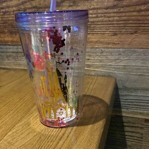 Castle tumbler with confetti and straw.